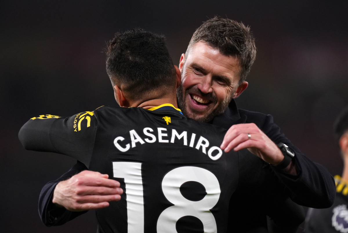 Michael Carrick embraces Casemiro after the win at Arsenal