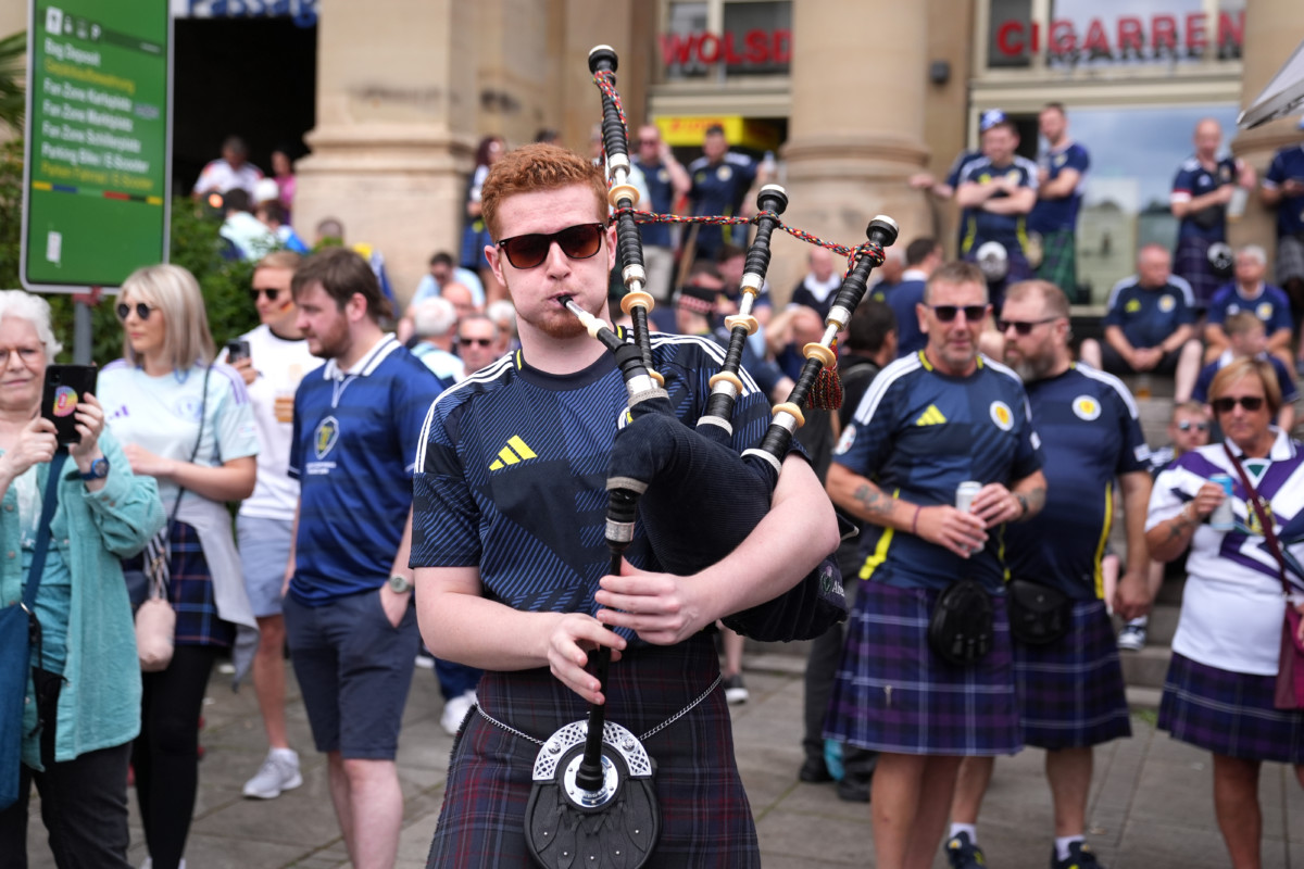 A Scotland fan plays the bagpipes wearing a sporran