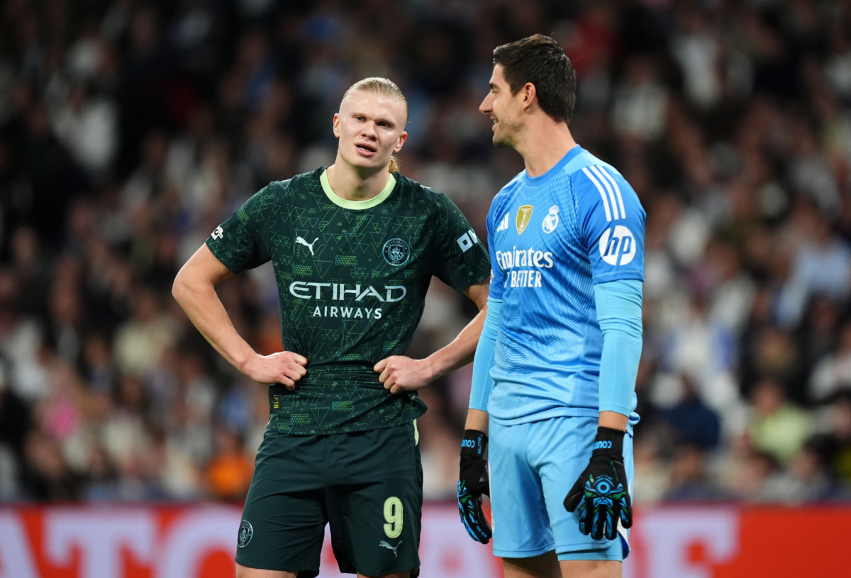 Manchester City’s Erling Haaland, left, speaks to Real Madrid goalkeeper Thibaut Courtois