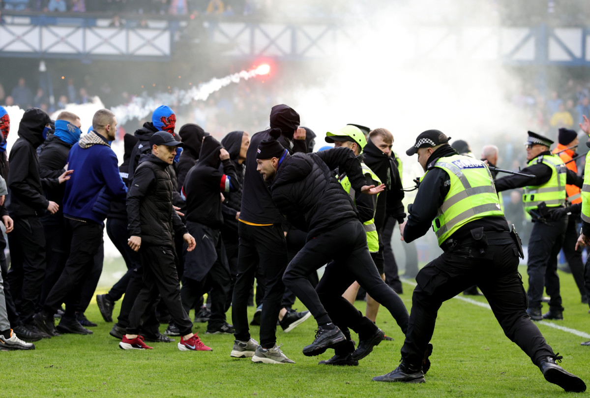 Police officers and stewards force Rangers fans back 